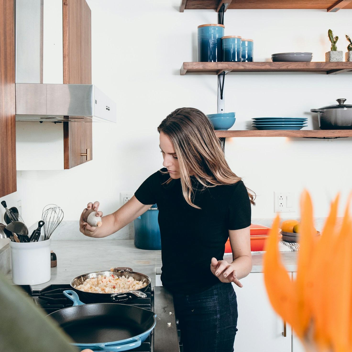 Community members collaborating in a modern kitchen space, sharing recipes and cooking techniques
